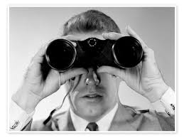 A man looking through binoculars.